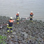 Eine Saugleitung wird zu Wasser (Elbe) gebracht.