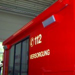 Markise linksseitig und Umfeldbeleuchtung, unterhalb des Fensters befindet sich der Geräteraum für den 8 kVA-Stromerzeuger